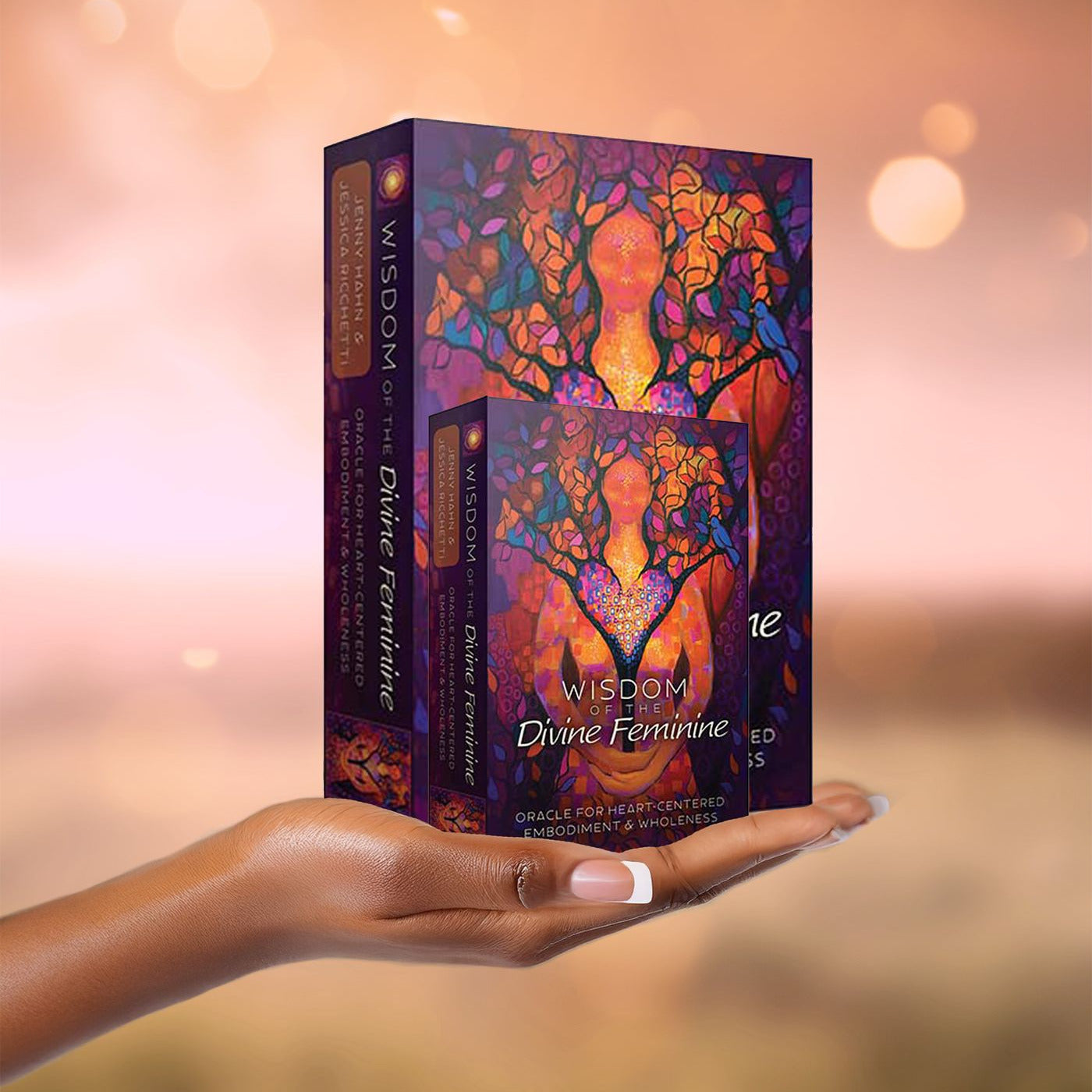 Black Woman's hand holding Wisdom of the Divine Feminine Oracle decks.