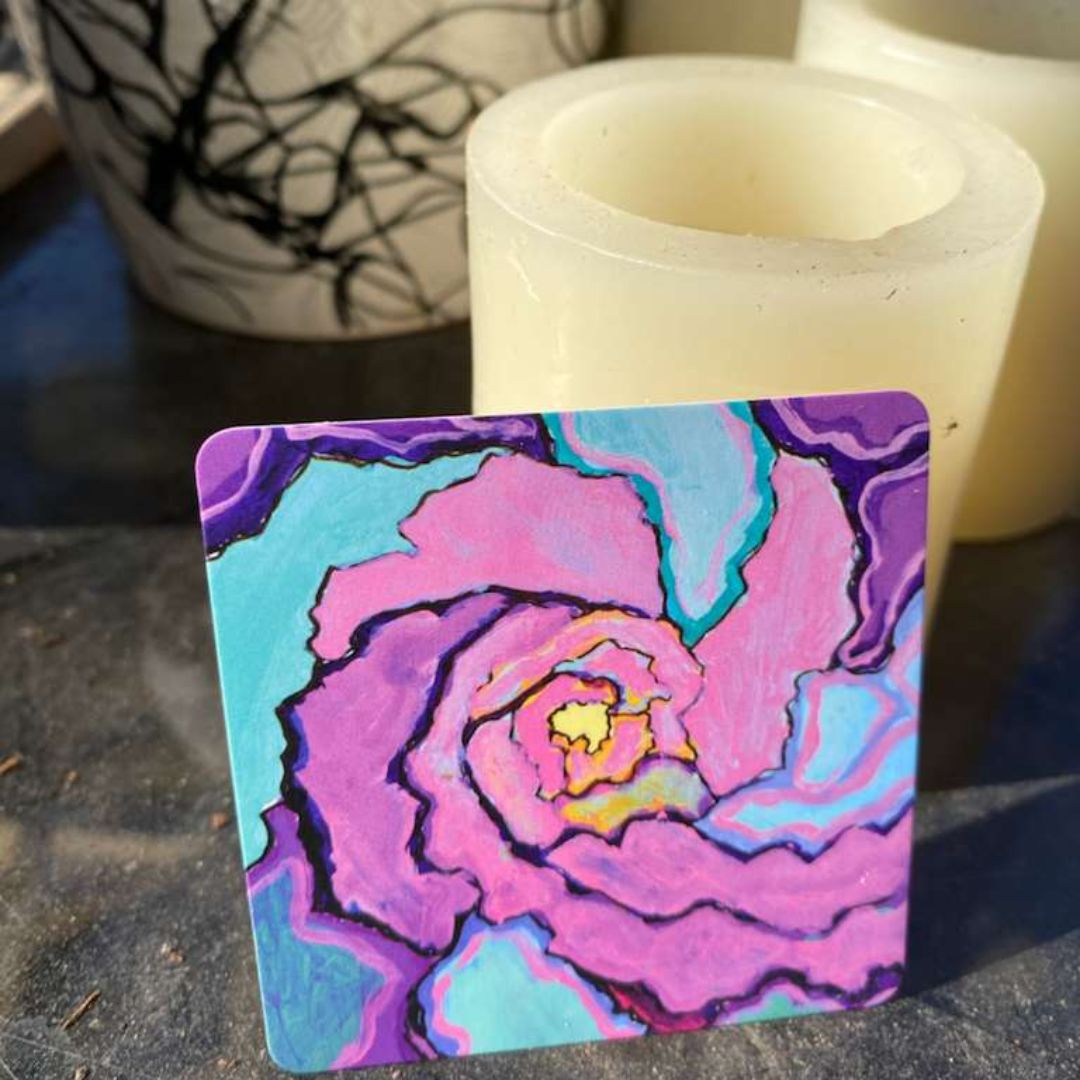 Pink, teal, and purple spirals, with a golden yellow glow radiating from the center. Art by Jenny Hahn